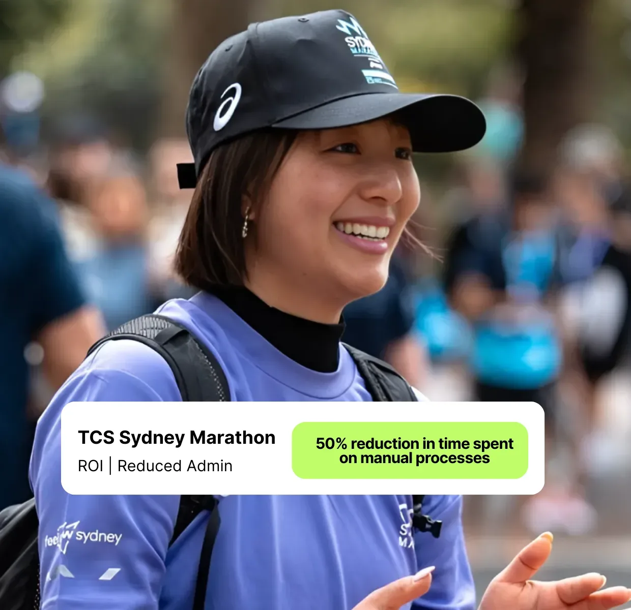 TCS Sydney Marathon Volunteer in purple tshirt and cap clapping