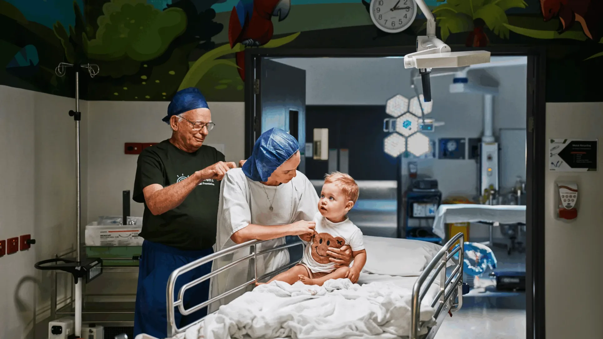 Volunteer helping mum and child get prepped for surgery