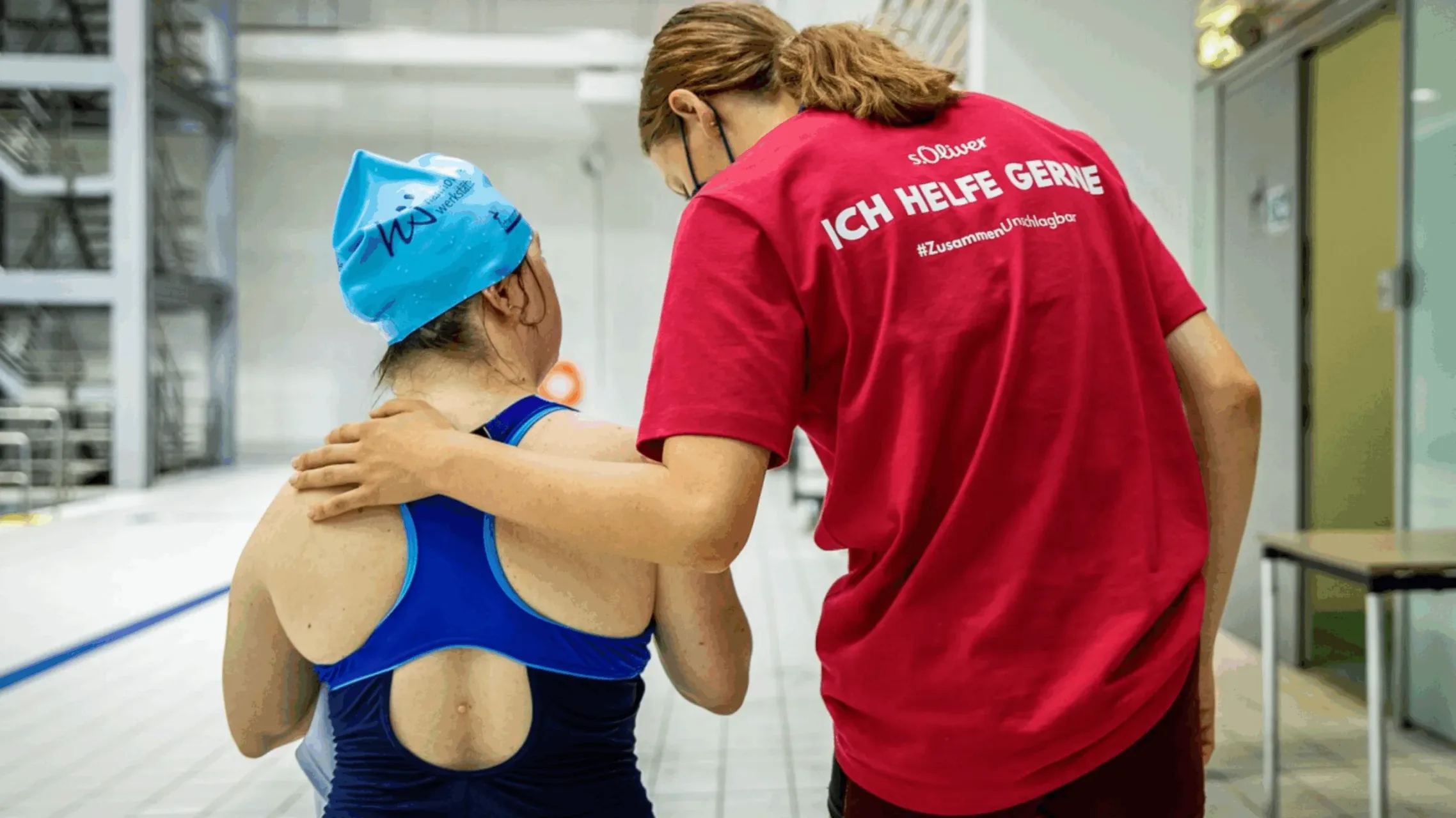 Volunteer helping to guide an athlete