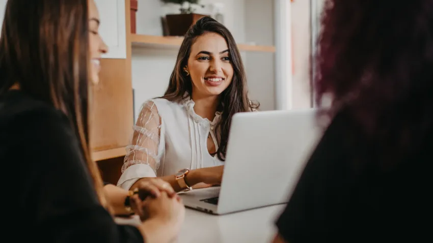Woman looking at her laptop smiling