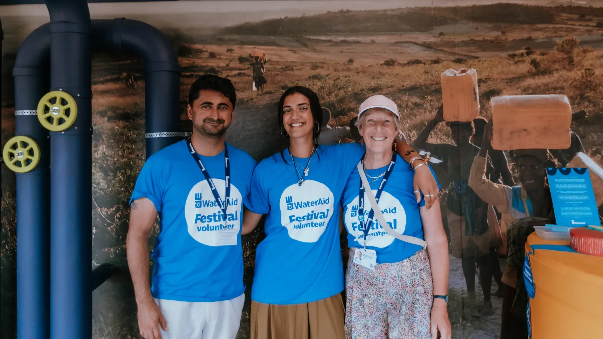 WaterAid volunteers smiling at an event