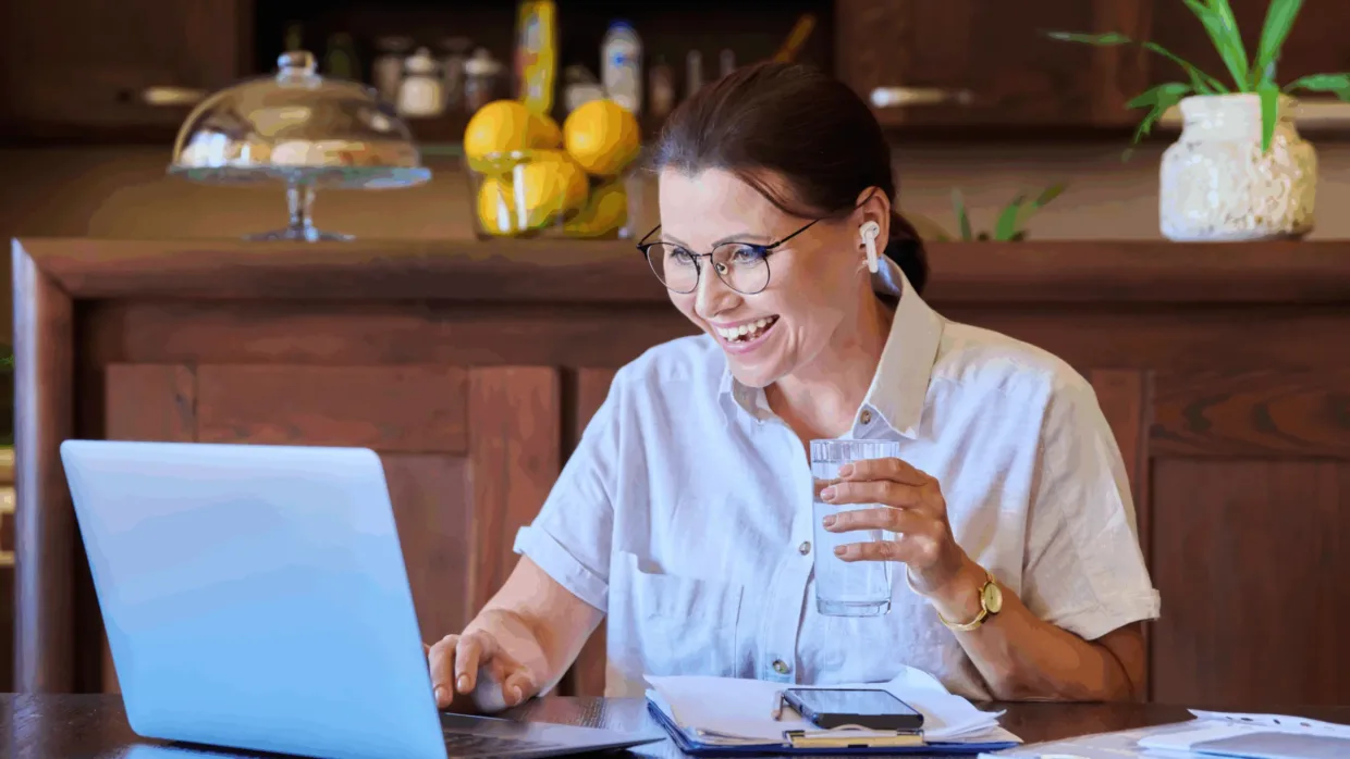 Woman on laptop with headphones