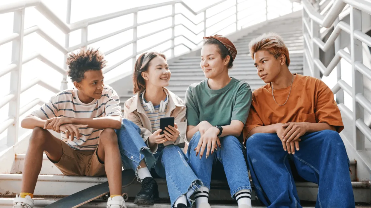 Group of young people sitting on stairs