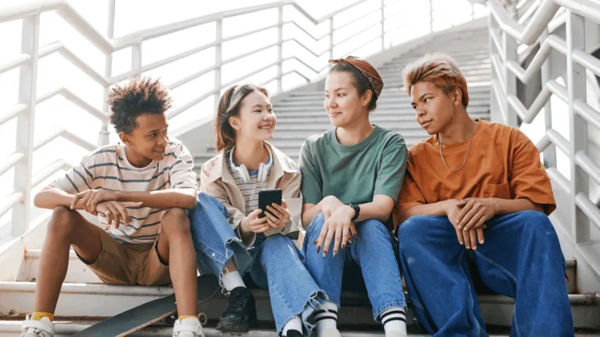 Group of young people sitting on stairs