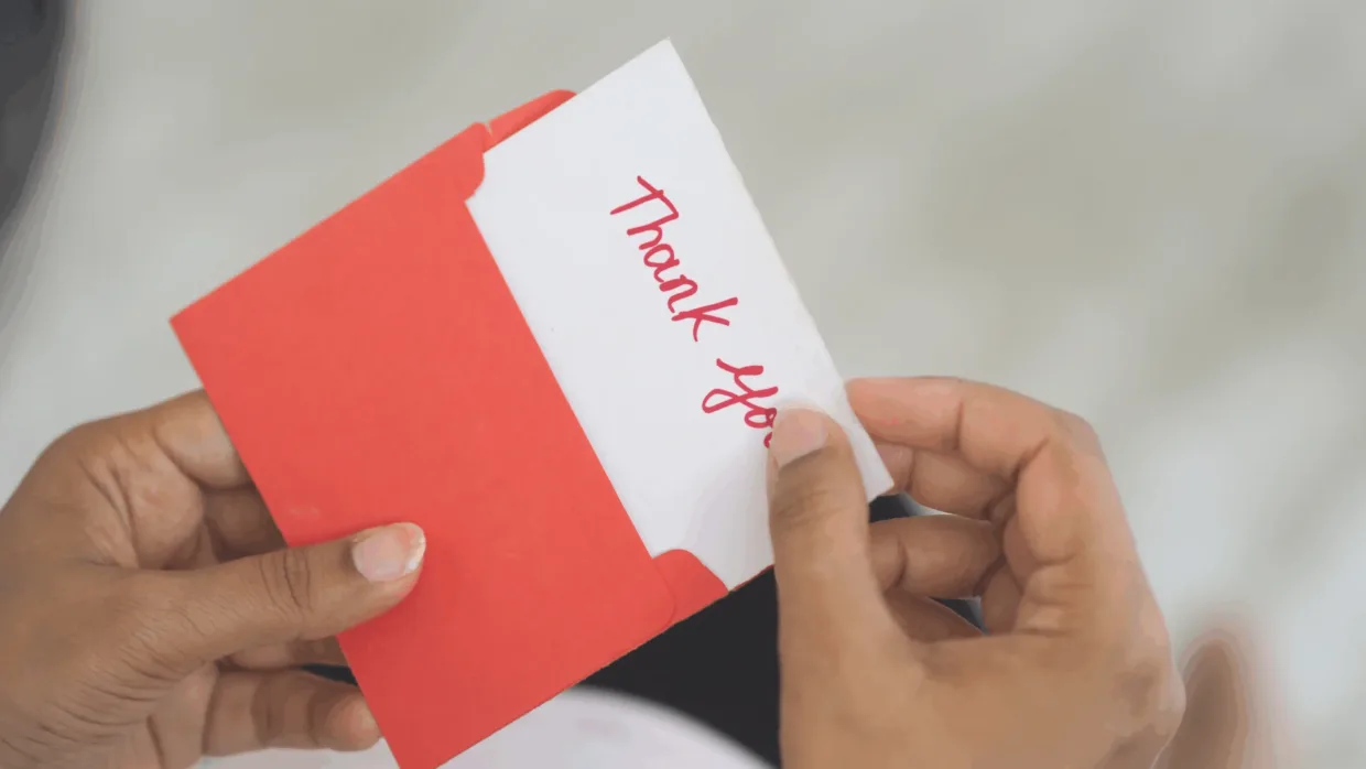 Opening a thank you card