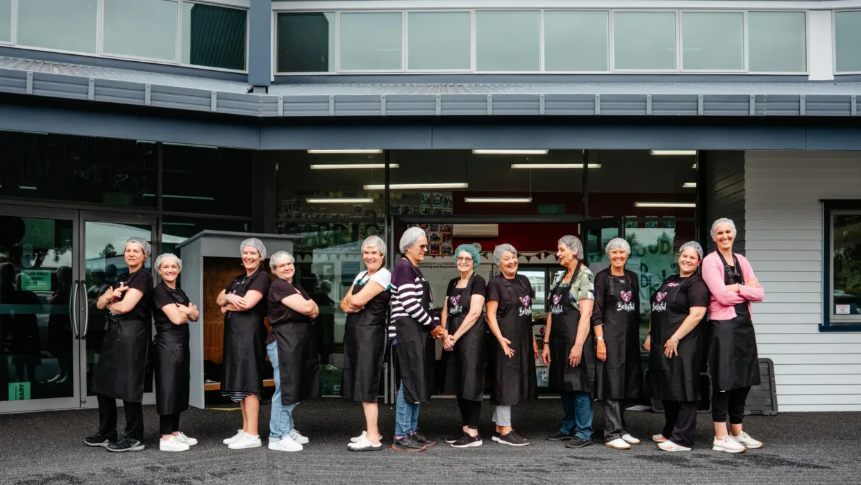 Bellyful NZ volunteers with hands on their hearts, posing for a photo
