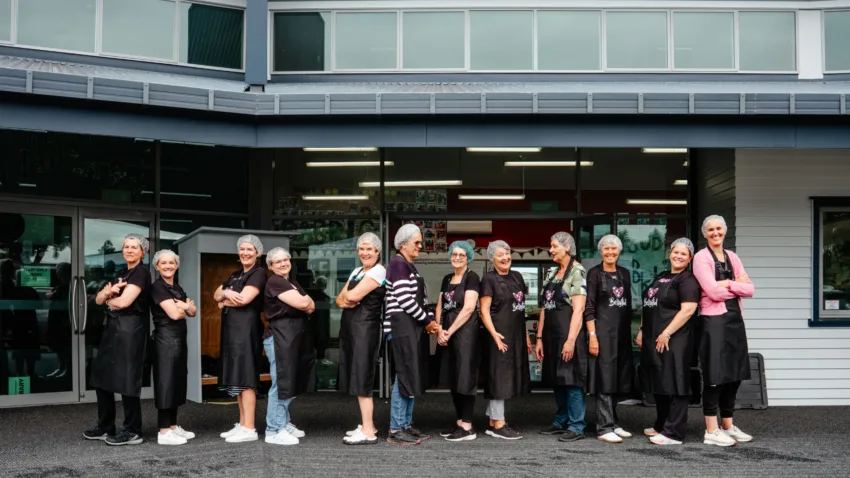 Bellyful NZ volunteers with hands on their hearts, posing for a photo