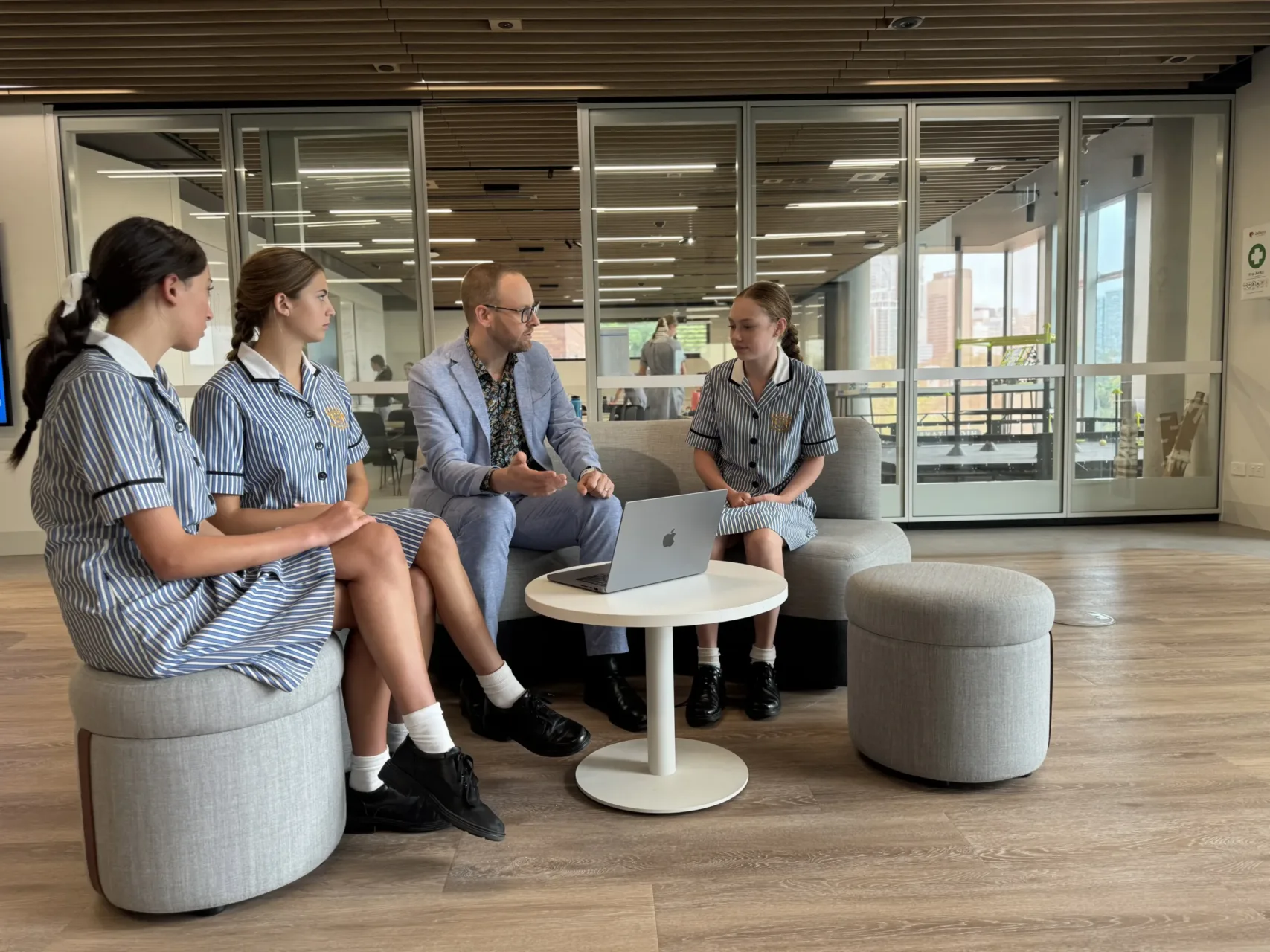 Loreto Kirribilli students talking to teacher in casual common area