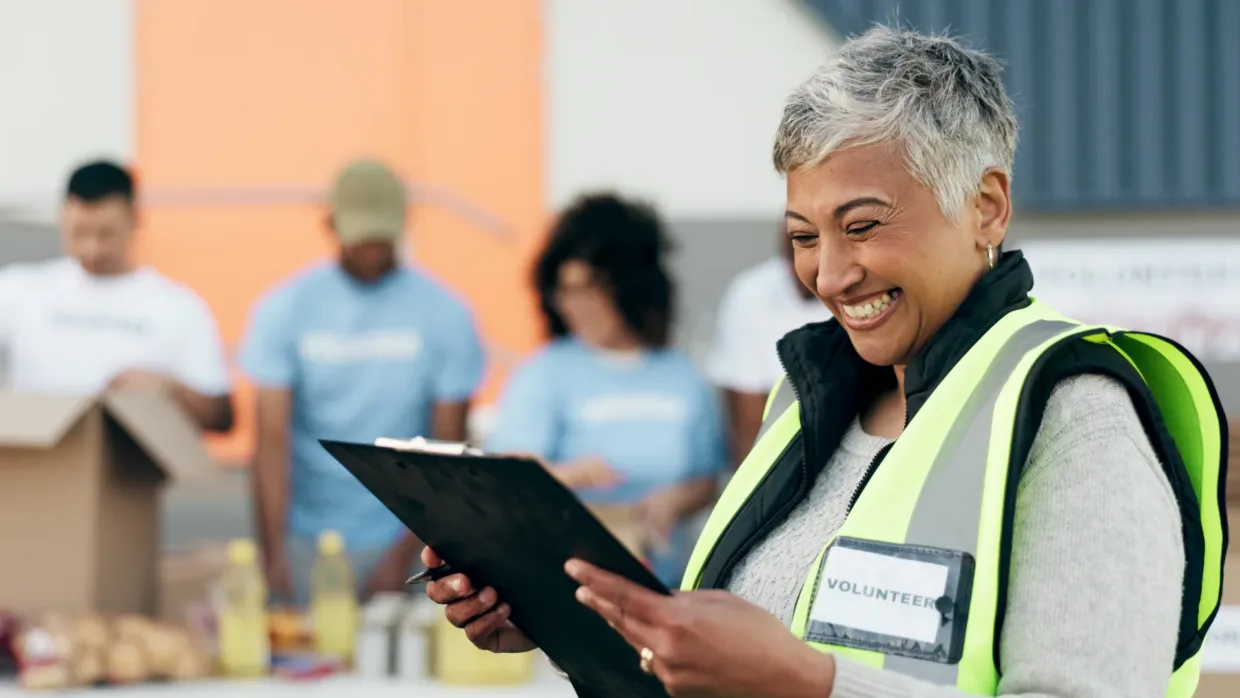 Lady with a clipboard on site wearing high vis