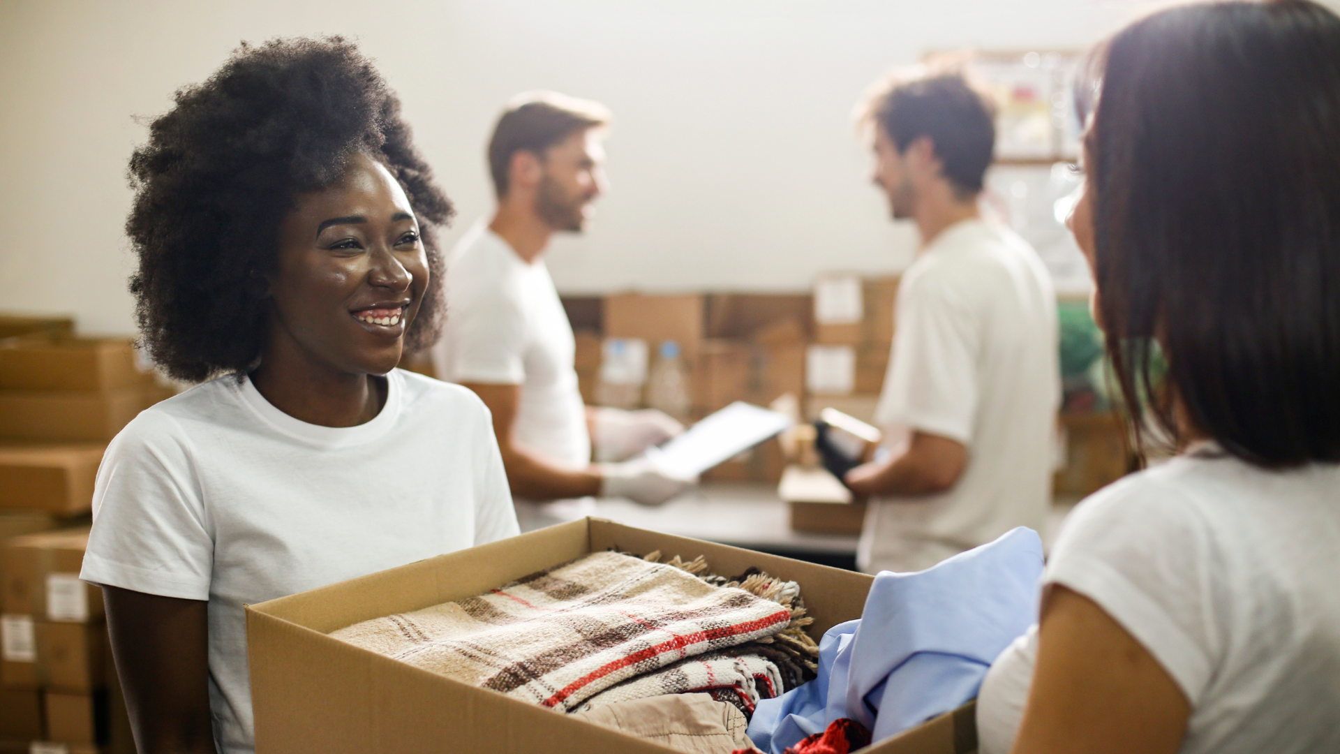 Image of volunteer passing boxes