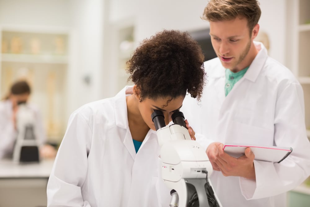 Medical students working with microscope at the university-1