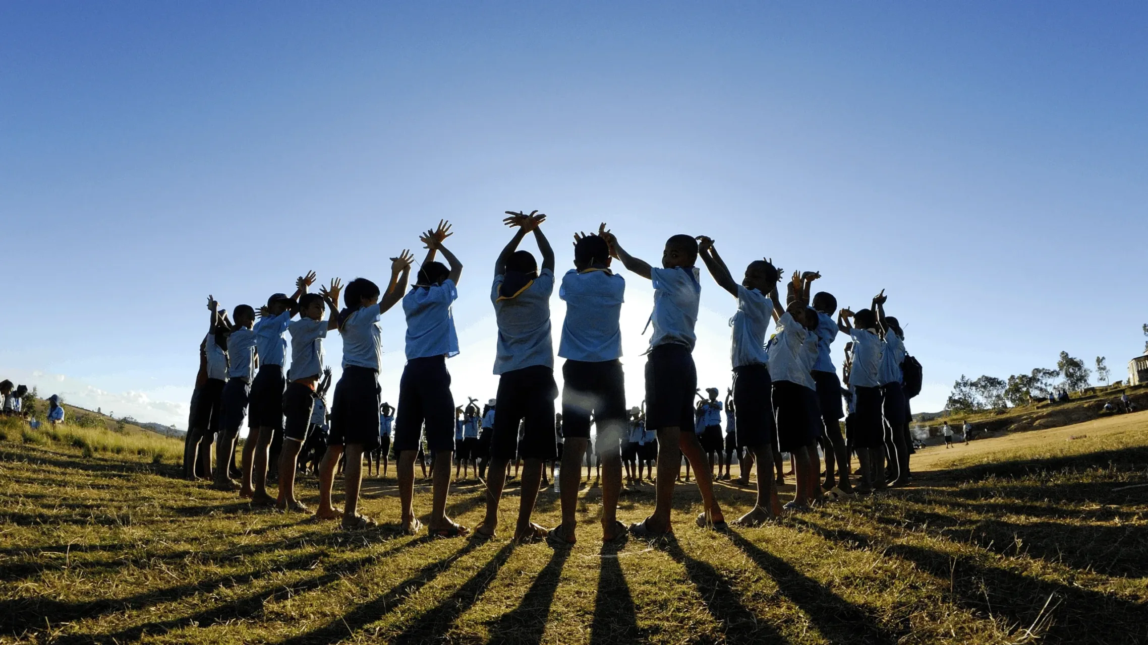 Group of Scouts volunteers with hands in the air