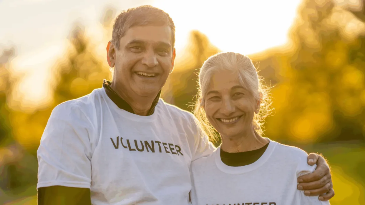 Two senior volunteers smiling