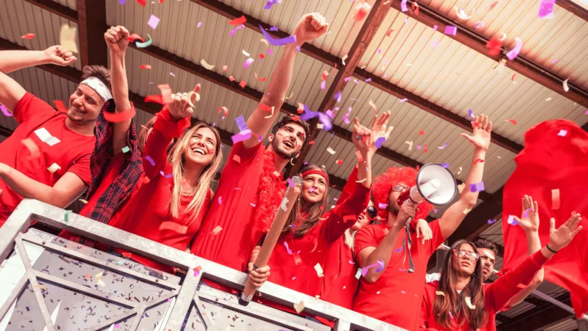 Cheering group of fans dressed in red