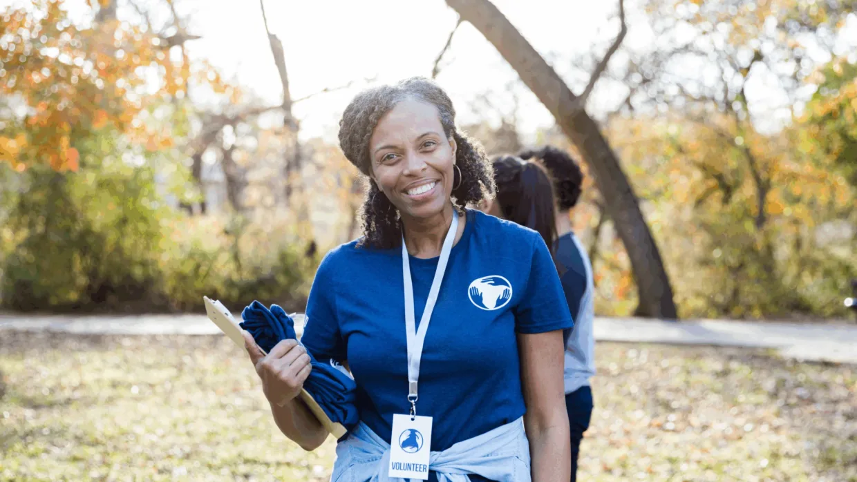 Volunteer smiling with clipboard