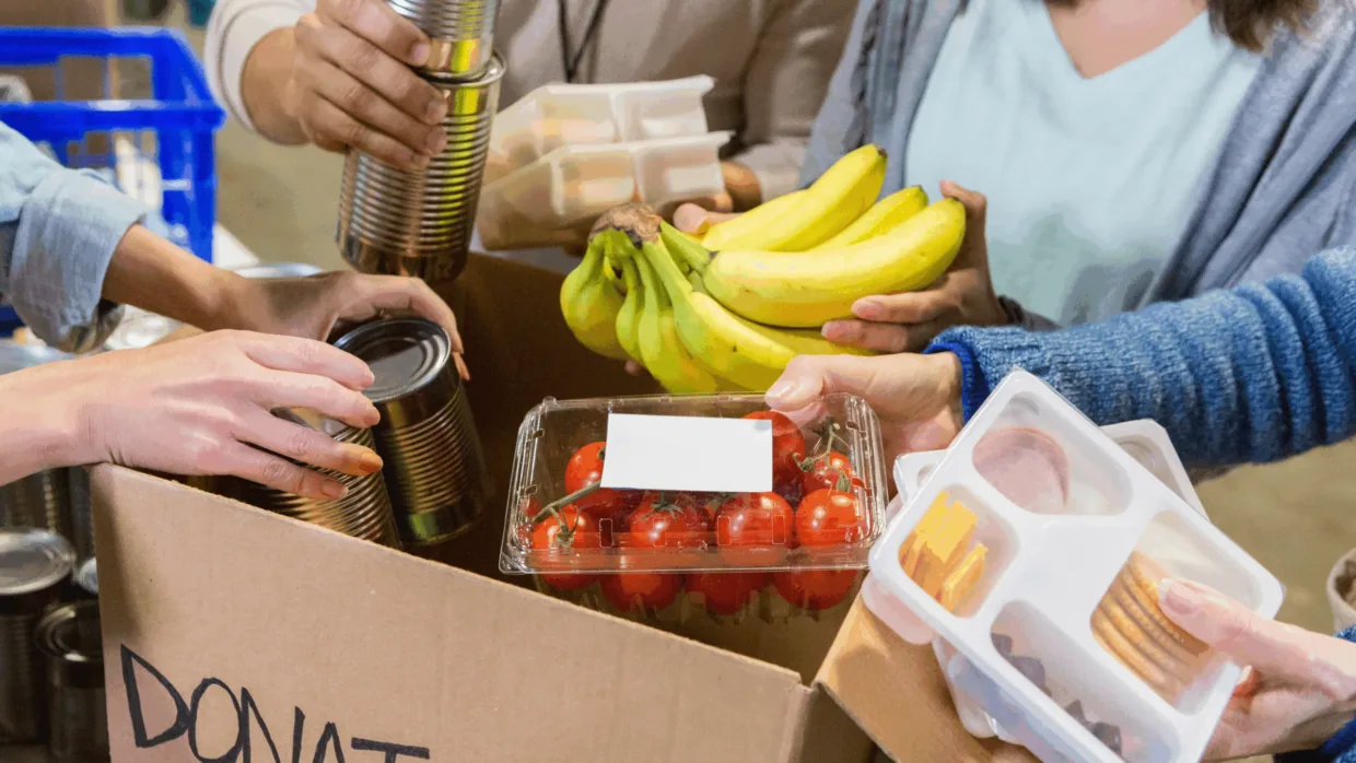 Packing food items into a donation box