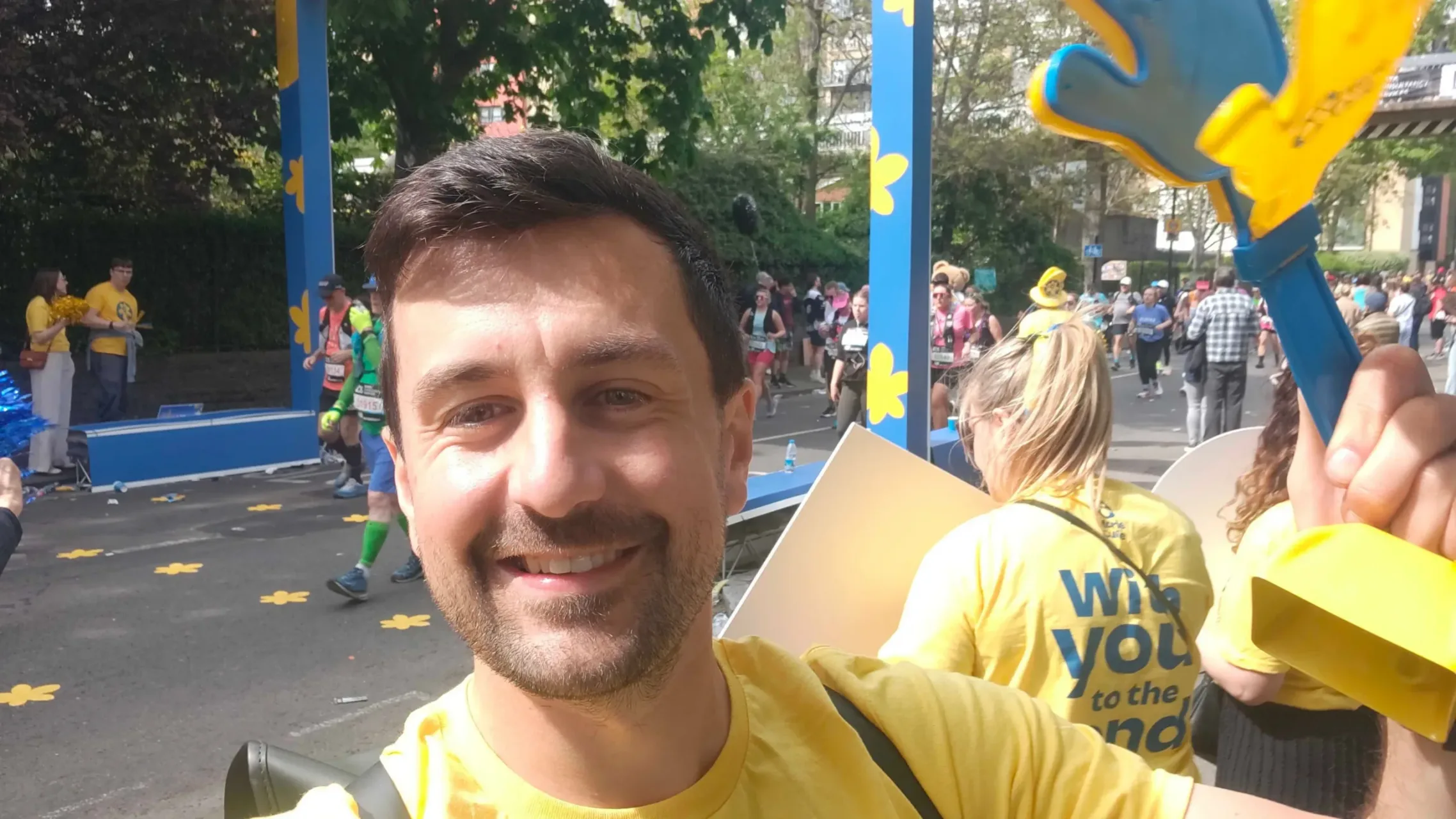 Sam Bennett from Rosterfy volunteering at the Marie Curie cheer station at the London Marathon 2026