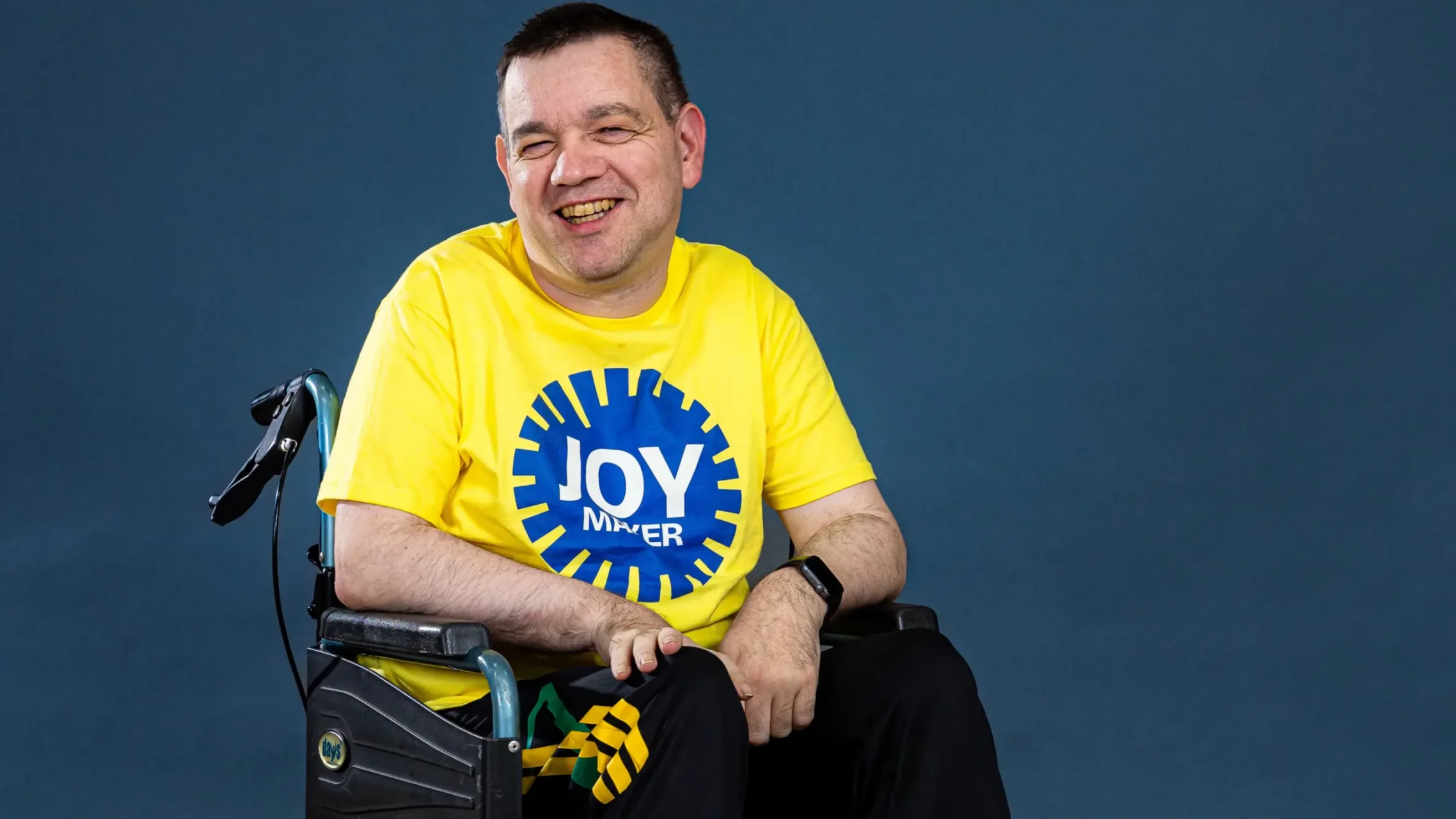 Grand Depart GB volunteer in wheelchair smiling at camera