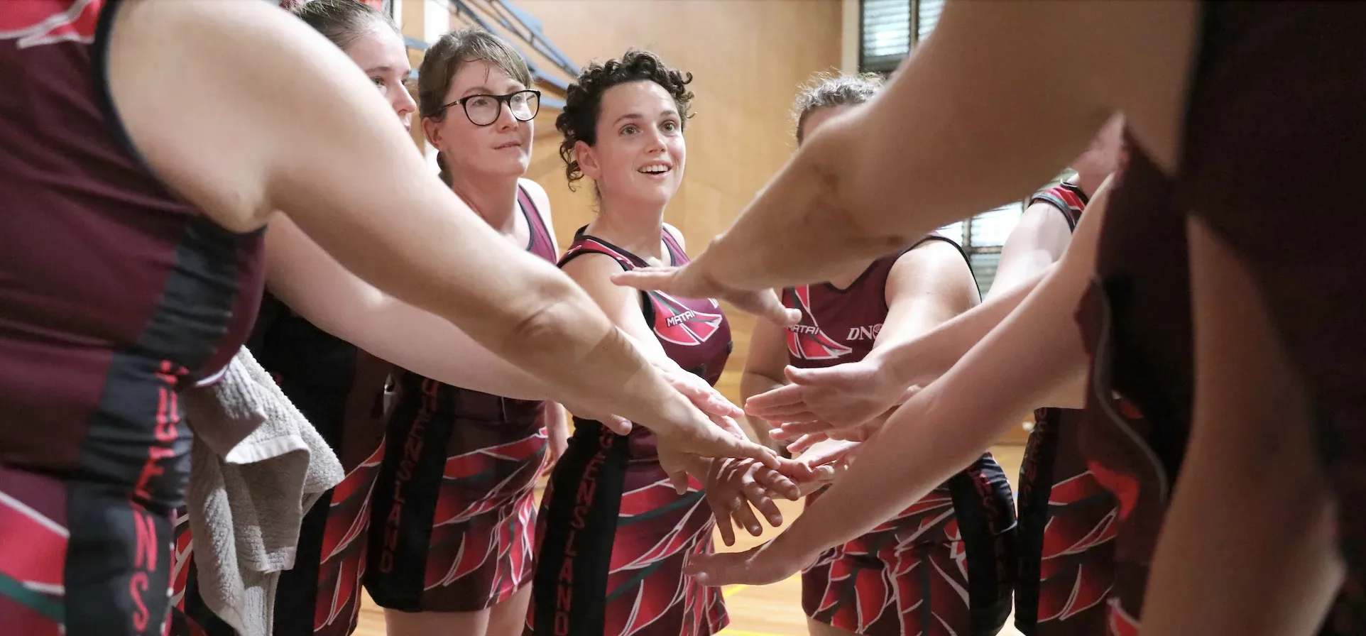 Deaf Sports Australia participants in a team huddle for basketball game