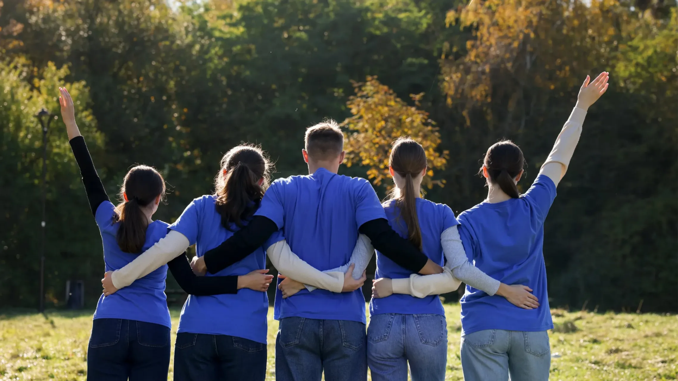 Group of volunteers with arms around one another