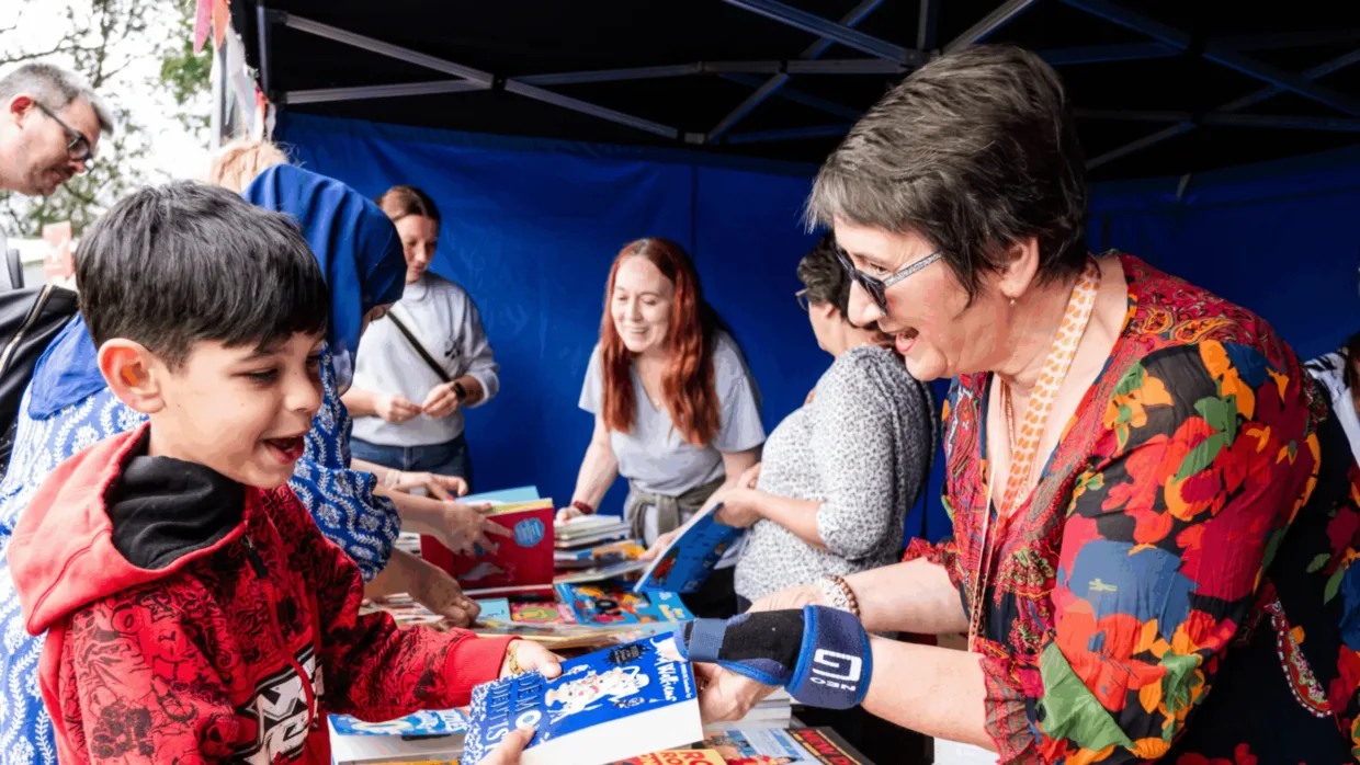 National Literacy Trust volunteer handing out books