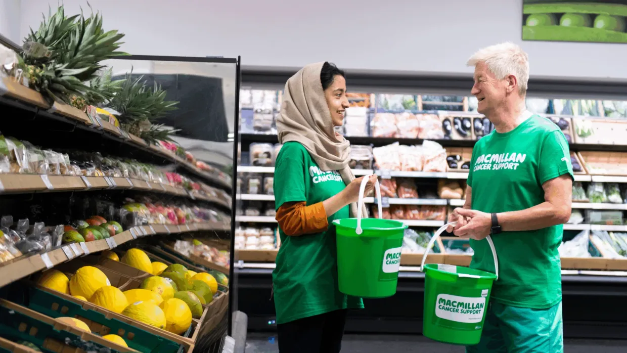 Macmillan Cancer Support volunteers in a grocery store fundraising money