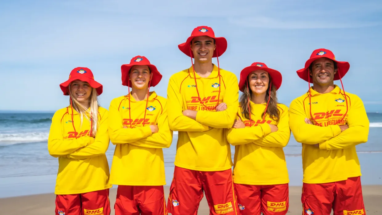 NZ lifeguards standing with their arms crossed on the beach