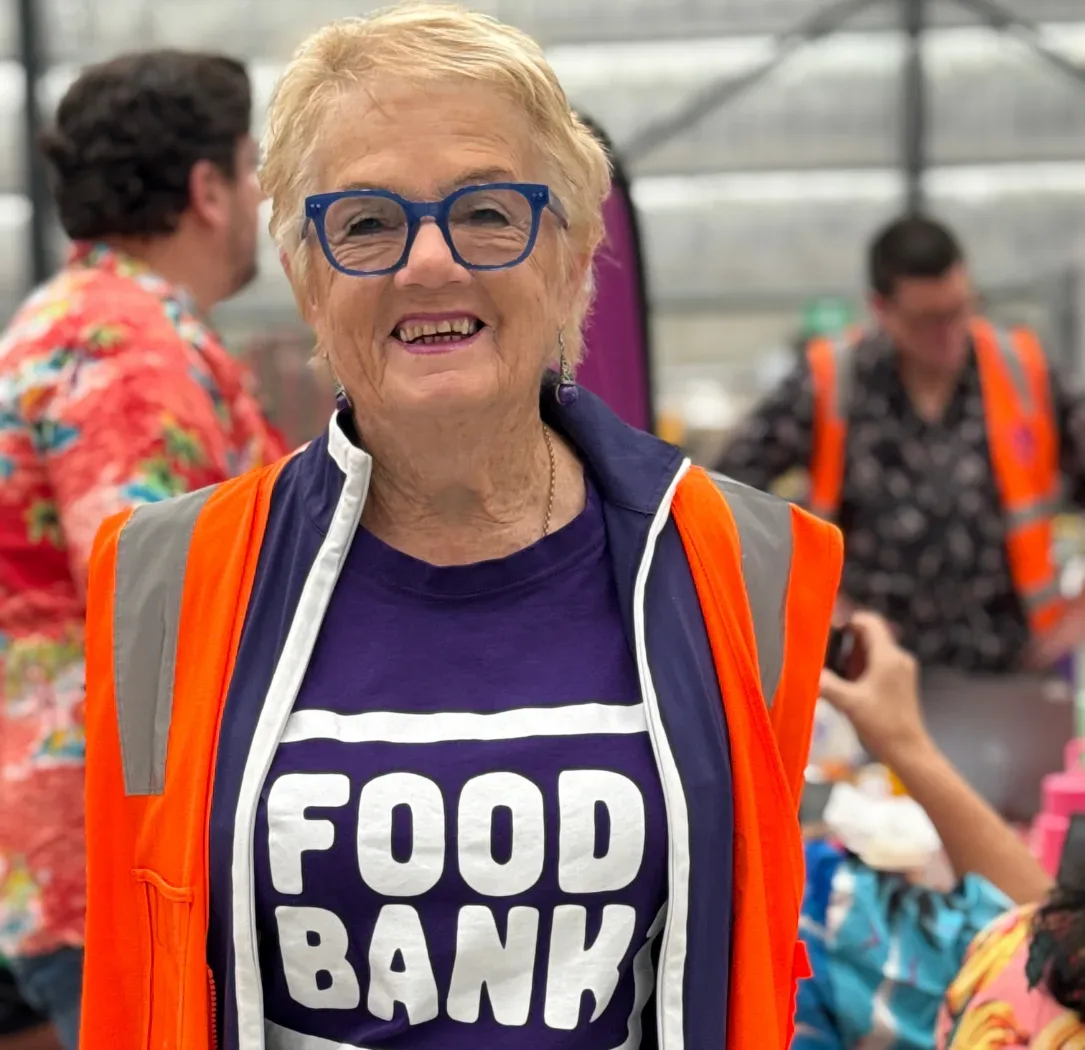 FoodBank Victoria Volunteer in high vis smiling at camera