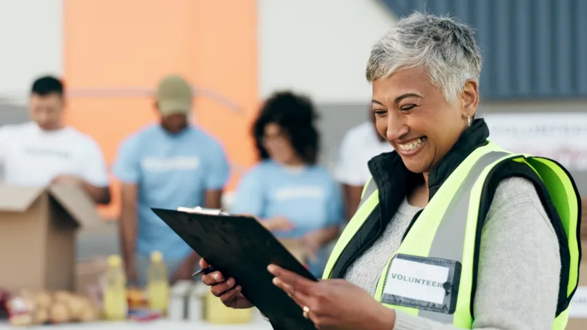 Lady with a clipboard on site wearing high vis