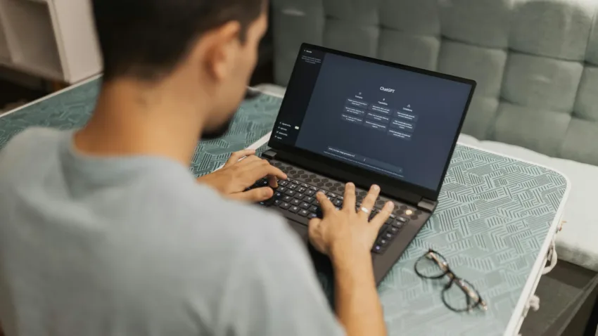 Man on his laptop with Chat GPT on his screen